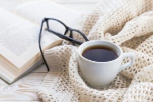 book with coffee and blanket